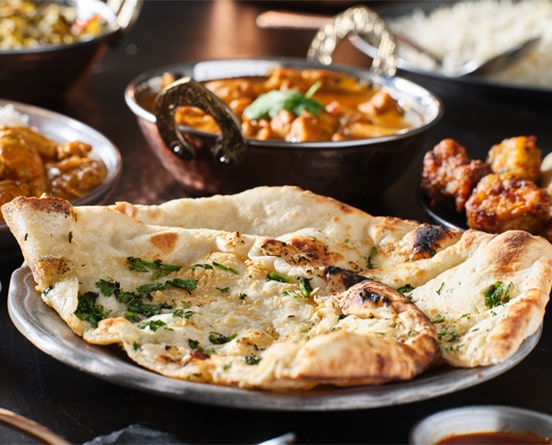 Our menu includes perfectly baked naans to accompany your meal